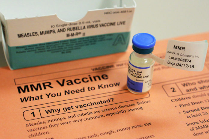 A vial of measles, mumps and rubella vaccine and an information sheet is seen at Boston Children's Hospital in Boston