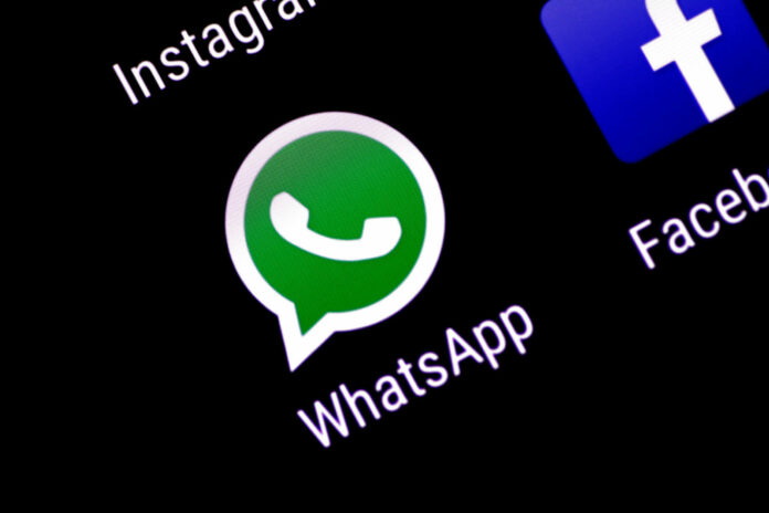 The WhatsApp messaging application is seen on a phone screen