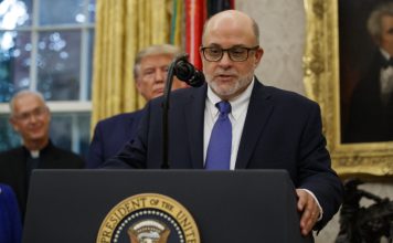 Mark Levin speaks, with President Donald Trump behind him (AP Photo/Alex Brandon)