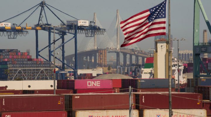 FILE - Containers with Yang Ming Marine Transport Corporation, a Taiwanese container shipping company, are stacked up at the Port of Los Angeles with the the Long Beach International Gateway Bridge seen in the background on Wednesday, April 9, 2025 in Los Angeles. (AP Photo/Damian Dovarganes, File)