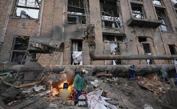 Workers clean up damage at Darnytsia Thermal Power Plant after a Russian attack in Kyiv, Ukraine, Wednesday, Feb. 4, 2026. (AP Photo/Sergei Grits)