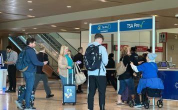 People walk through TSA PreCheck at Dallas Love Field on Sunday, Feb. 22, 2026. (AP Photo/Jamie Stengle)