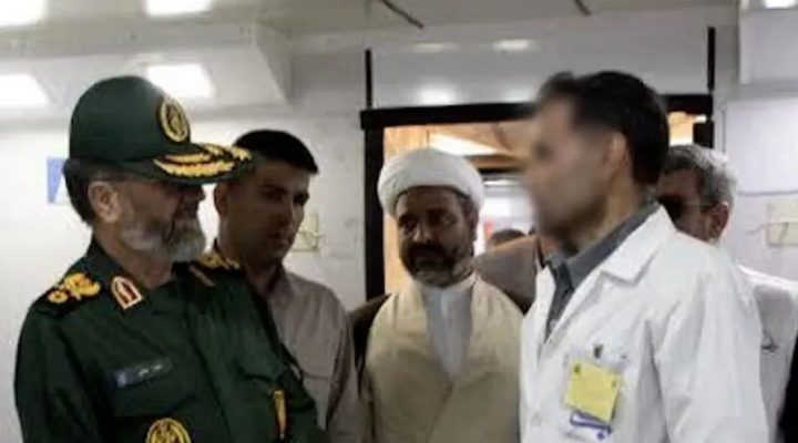 Iranian military and clerical officials visit a hospital ward, speaking with medical staff. (Photo: Iran International)