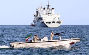 Illustrative. Iranian seamen pilot a speedboat near a Chinese Peoples’ Liberation Army Navy (PLAN) type 903A replenishment ship at sea during the Maritime Security Belt 2024 combined naval exercise between Iran, Russia, and China in the Gulf of Oman, March 12, 2024. (Iranian Army)