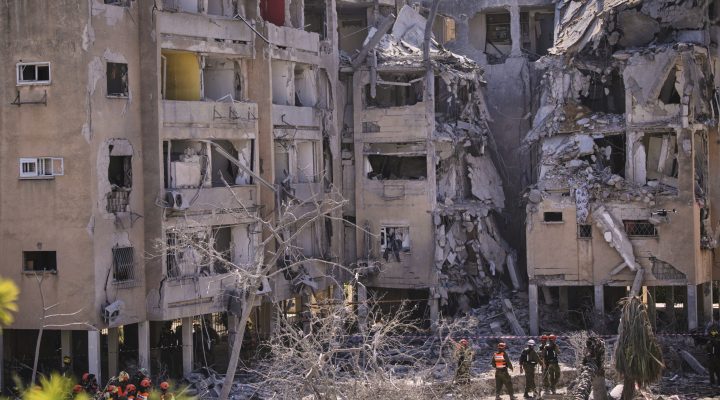 Israeli security forces inspect a destroyed building that was hit by a missile fired from Iran, in Holon, near Tel Aviv, Israel, Thursday, June 19, 2025. (AP Photo/Ohad Zwigenberg)